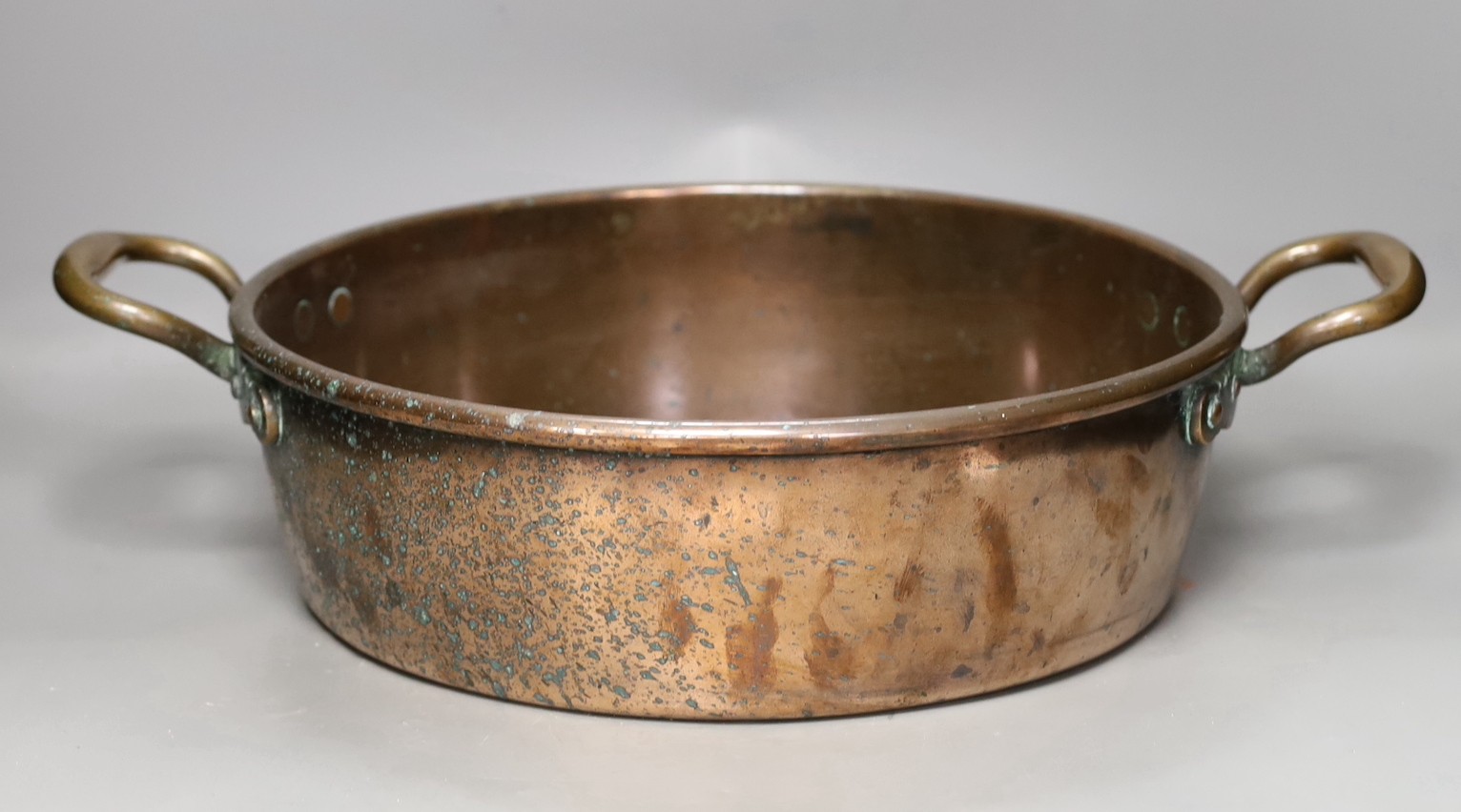 A 19th century copper two handled preserving pan, 51cms handle to handle